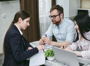 a couple reviewing personal loan documents with a loan expert